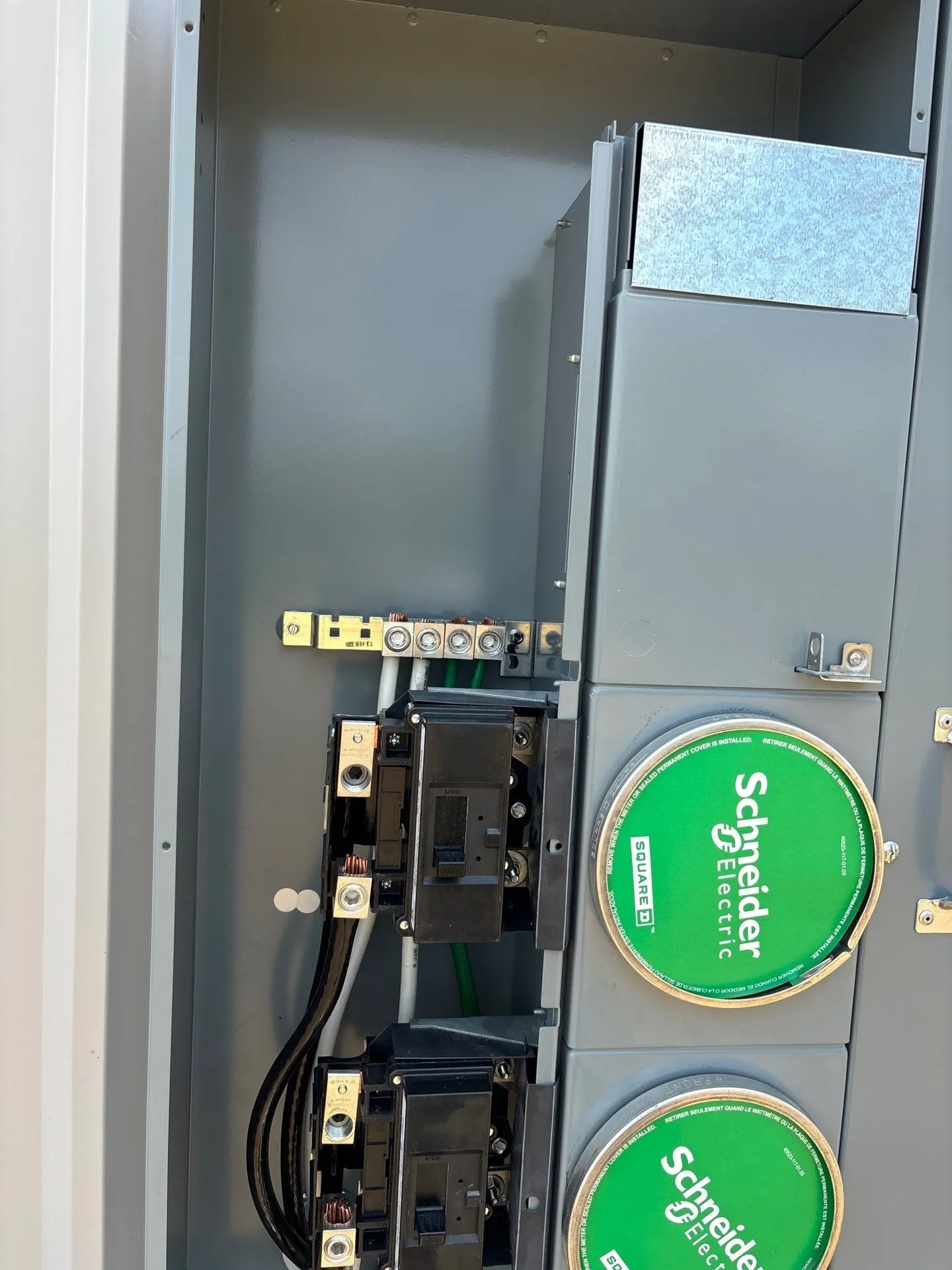New electrical distribution panels mounted inside a white-lined hangar