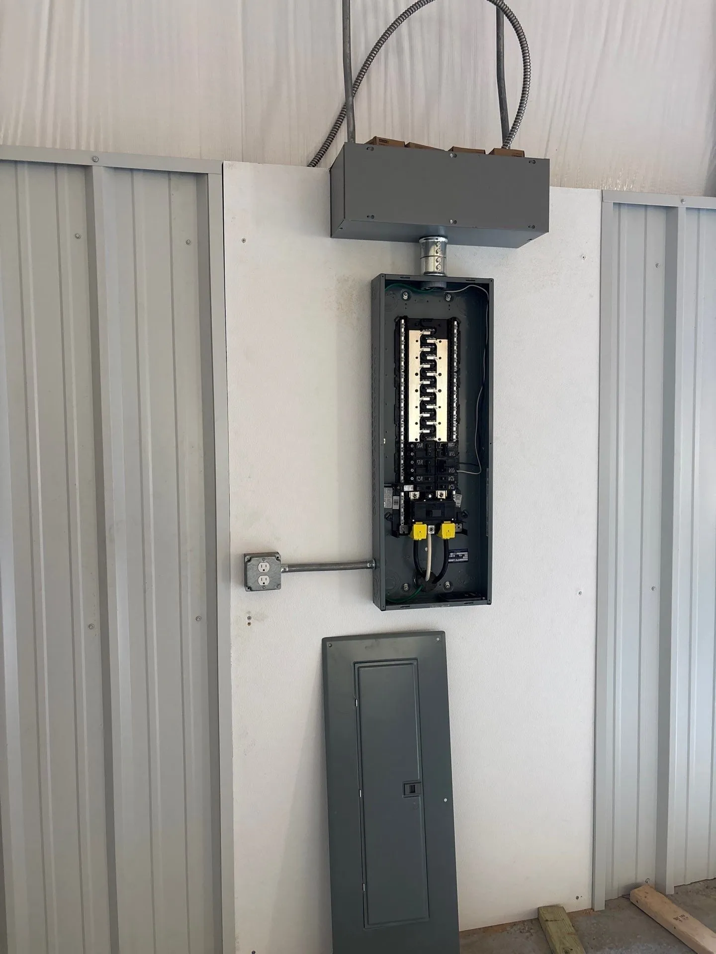 Electrical panel and disconnect on a hangar wall