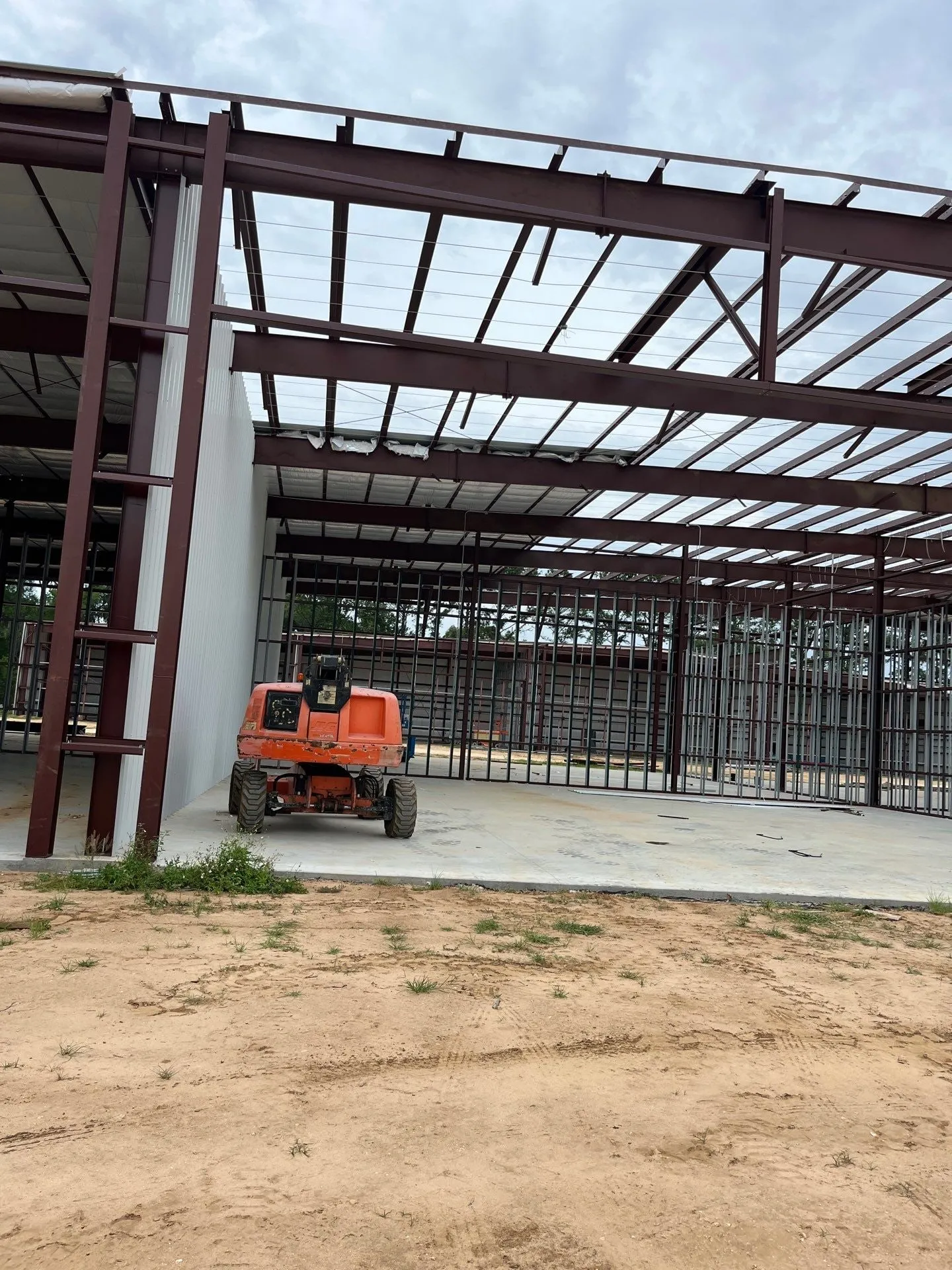 Steel hangar frames against the sky during erection