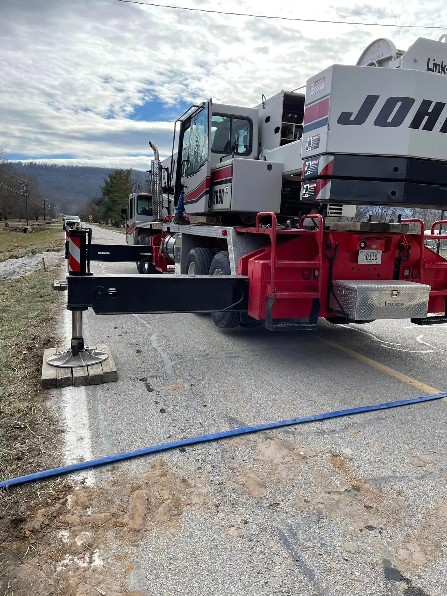 Horst Co crane truck set up with outriggers on a job site road