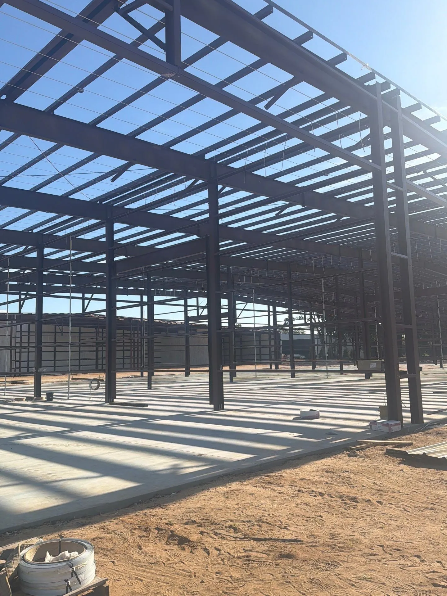 Steel hangar frames against the sky during erection