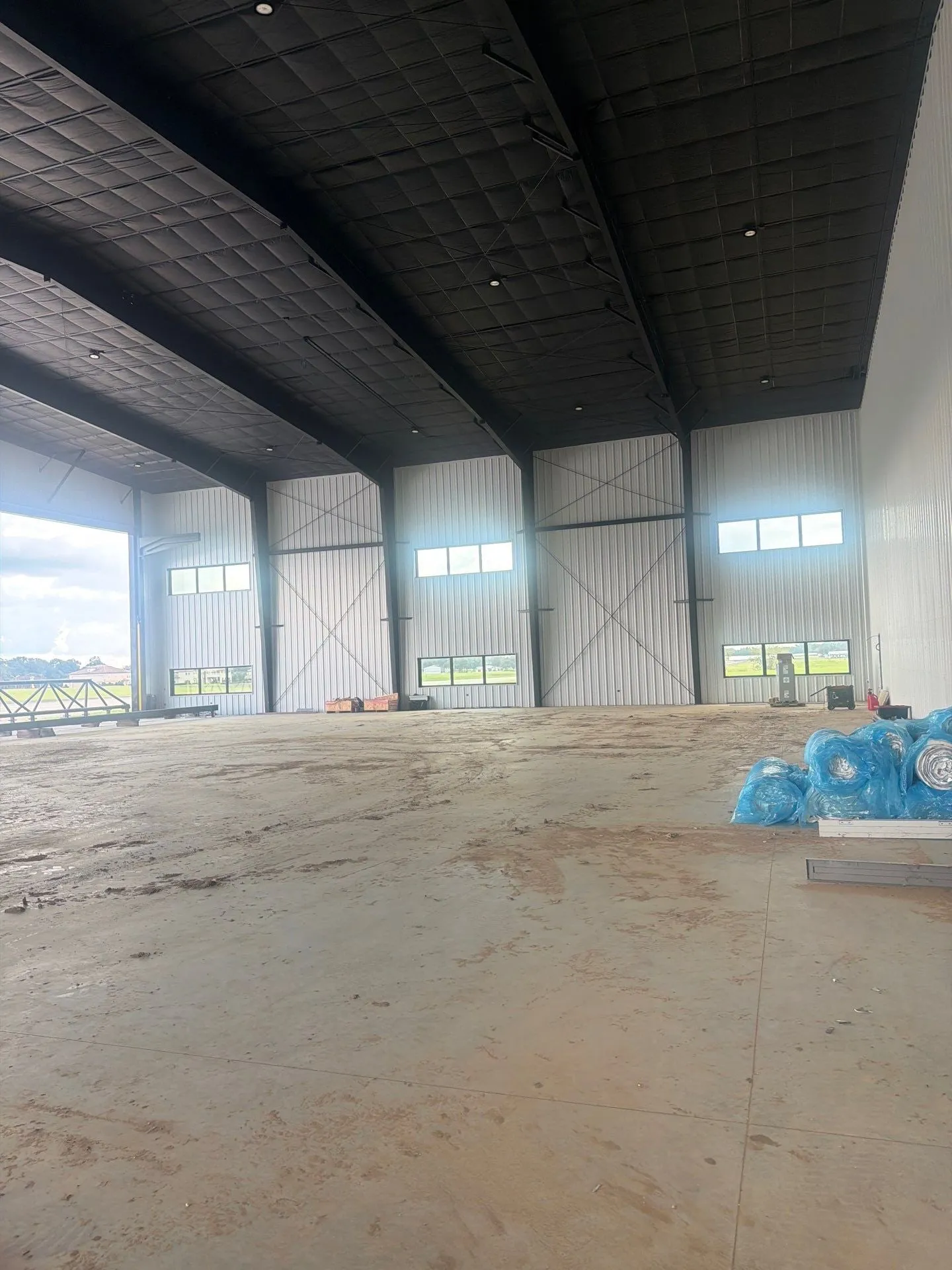 Finished hangar interior with white liner panels and clerestory windows