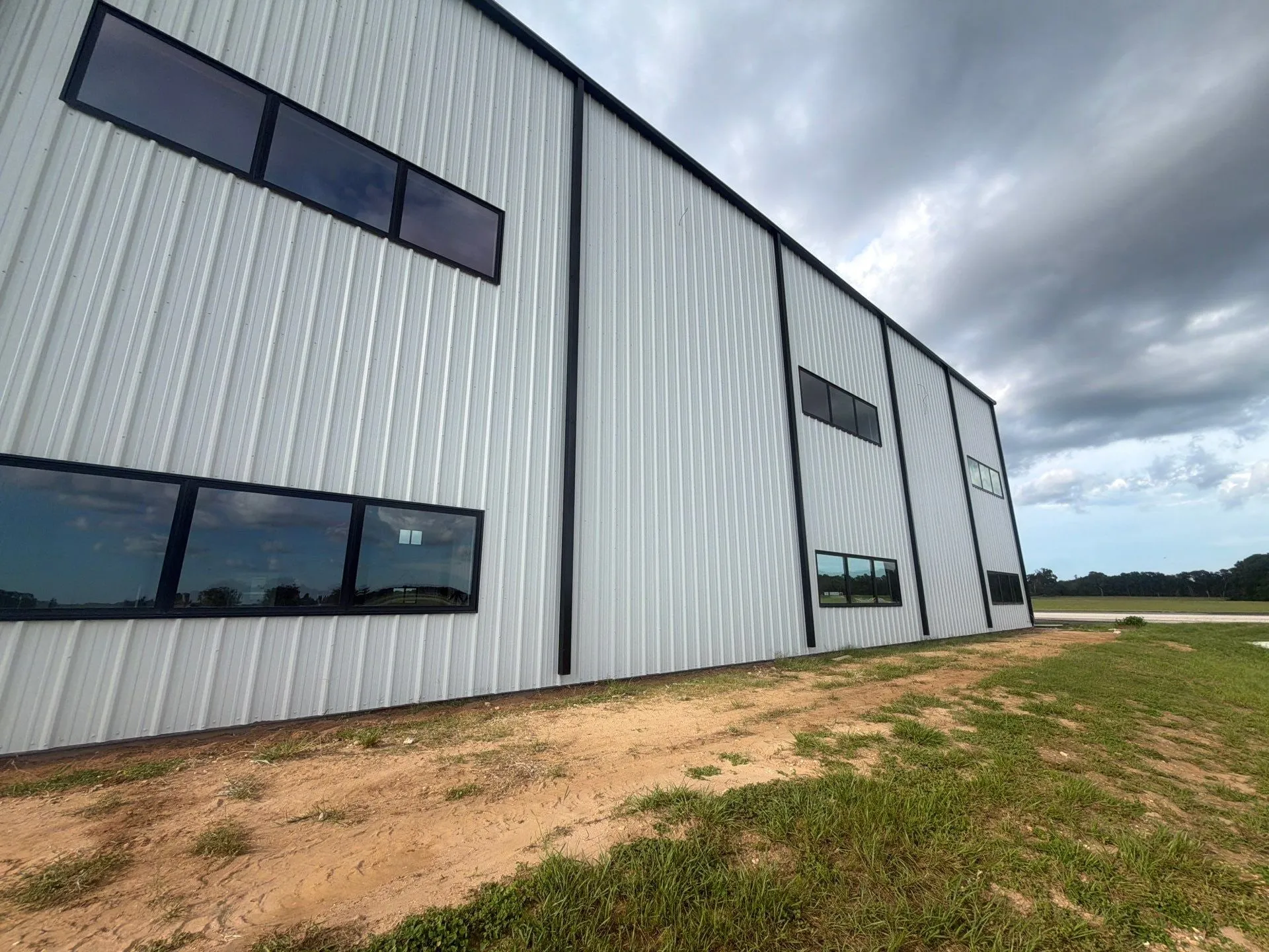 White hangar exterior with second-floor office windows
