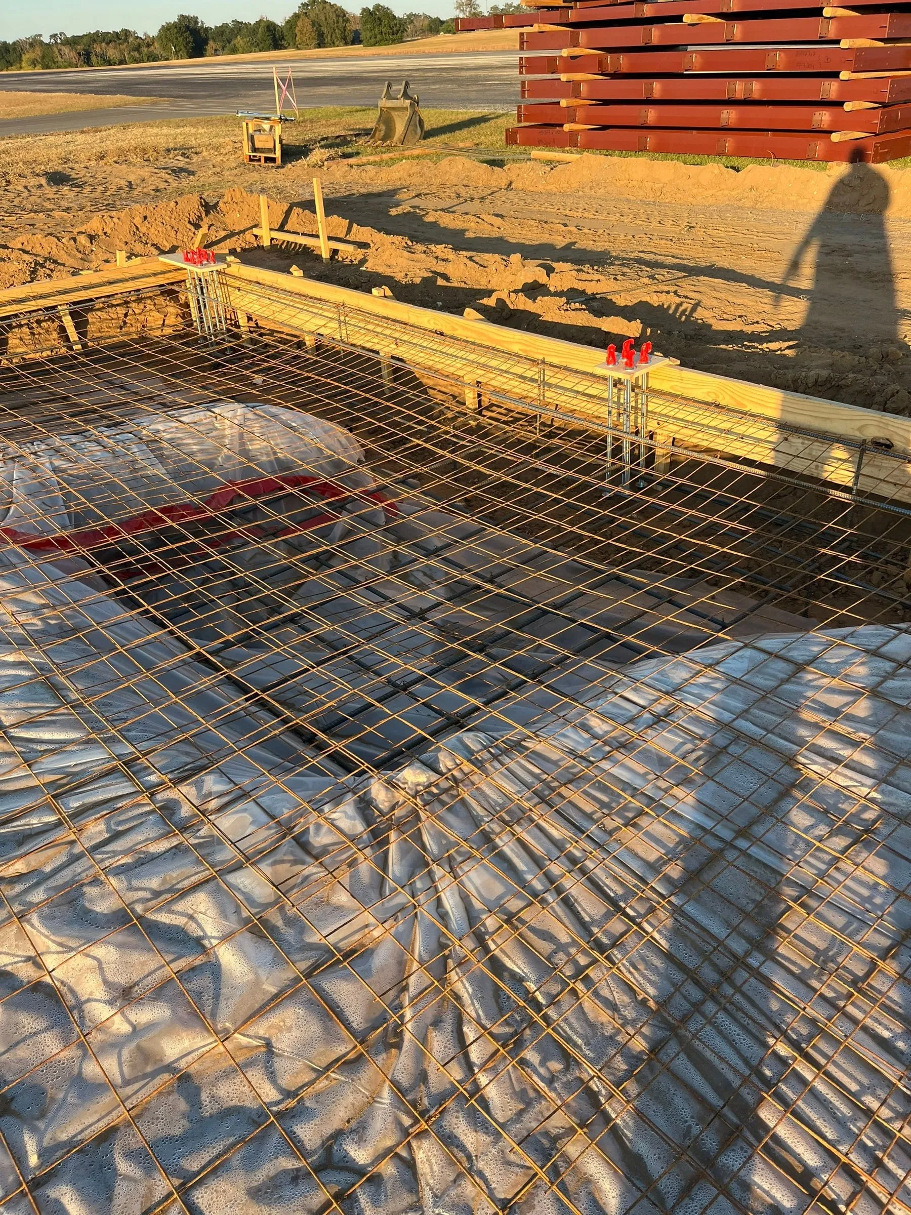 Rebar and vapor barrier laid out for a hangar slab