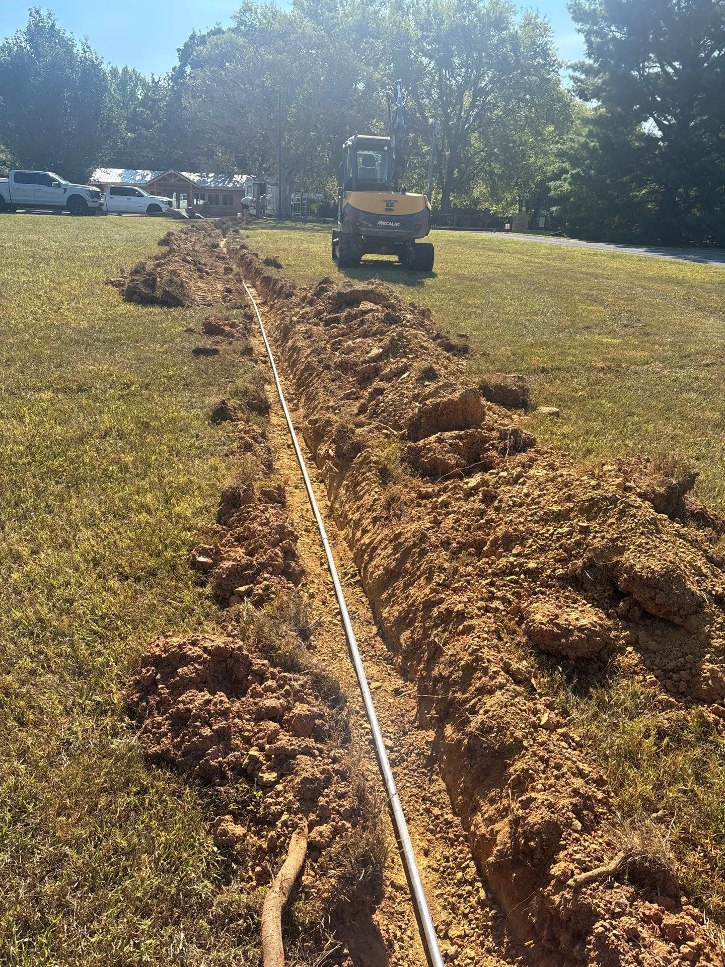 Feeder conduit laid in an open trench across the grounds