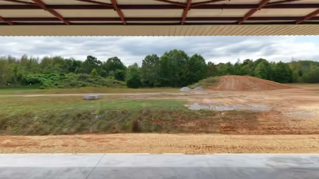 Hangar exterior with the hydraulic door raised and an aircraft inside