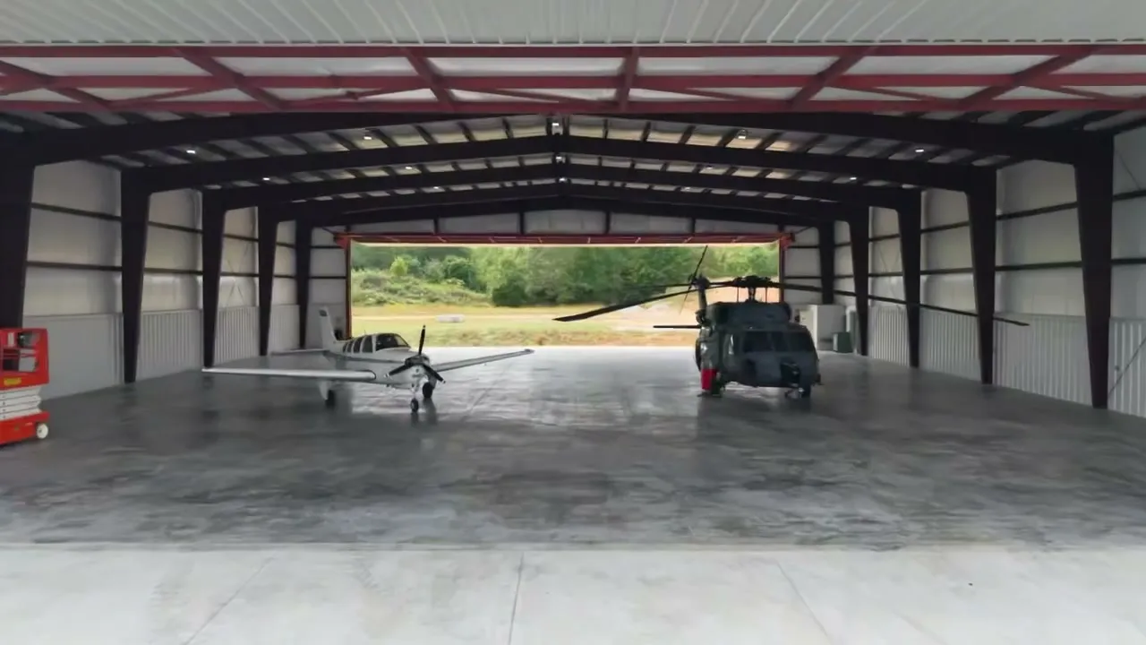 Helicopters parked inside one of the finished hangars with the hydraulic door open
